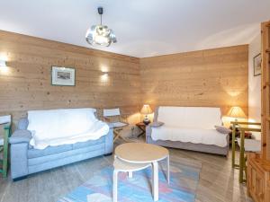 a room with two beds and a couch and a table at Appartement spacieux avec wifi, parking, balcon Sud à 10 min des commodités - FR-1-694-33 in Val dʼIsère