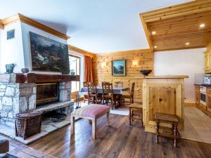 a living room with a fireplace and a table and chairs at Appartement Val-d'Isère, 4 pièces, 6 personnes - FR-1-694-213 in Val-d'Isère