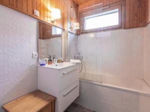 a white bathroom with a sink and a bath tub at Appartement Val-d'Isère, 3 pièces, 6 personnes - FR-1-694-309 in Val-d'Isère