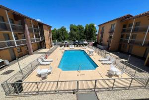 an overhead view of a swimming pool in a apartment complex at Days Inn by Wyndham Birmingham/West in Birmingham