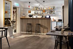 a restaurant with two tables and a bar at Palm Tree Hotel, Best Western Signature Collection in Trelleborg