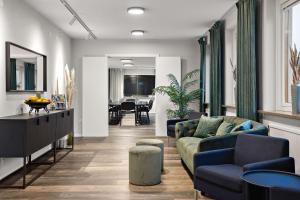 a living room with a couch and a dining room at Palm Tree Hotel, Best Western Signature Collection in Trelleborg
