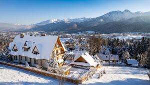 an aerial view of a house in the snow at Aparthotel Delta Top in Kościelisko