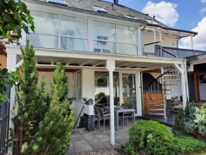 a home with a patio with a table and chairs at Biggi in Trittenheim