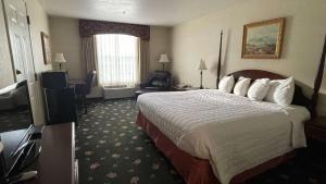 a hotel room with a large bed and a television at SureStay Hotel by Best Western Eureka in Eureka +11 photos