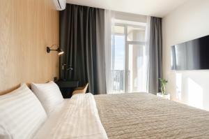 sypialnia z dużym łóżkiem i dużym oknem w obiekcie 18037 Designer apartments in the residential complex "Yaroslaviv Grad" w Kijowie