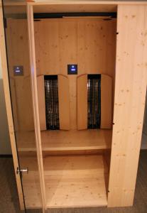 a wooden cabinet with servers inside of it at Design-Apartment am Plöner See in Ascheberg