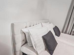 ein weißes Sofa mit Kissen darauf im Zimmer in der Unterkunft Residential Hotels Helsinki Center in Helsinki