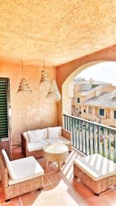 a living room with a balcony with wicker furniture at Luxury Apartments Mascarat in Altea