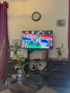 Lala salama Kendwa villas في كيندوا: غرفة معيشة مع تلفزيون بشاشة مسطحة وطاولة