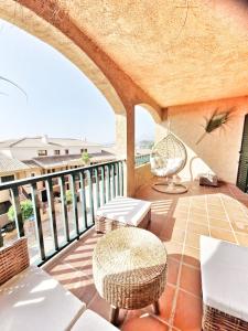 a balcony with a table and chairs on a balcony at Luxury Apartments Mascarat in Altea