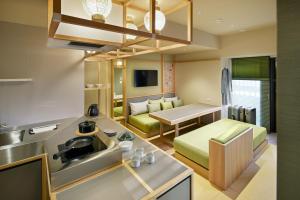 a kitchen and living room with a couch and a table at OMO5 Kyoto Gion by Hoshino Resorts in Kyoto