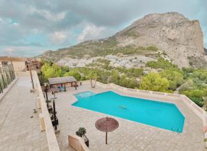 a swimming pool with a mountain in the background at Luxury Apartments Mascarat in Altea