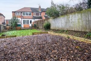 a backyard with a fence and a pile of dirt at 4 Bedroom House Near BHX, NEC & HS2 in Birmingham