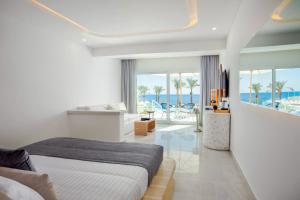 a bedroom with a bed and a view of the ocean at White Hills Resort in Sharm El Sheikh