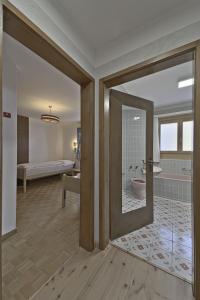 a room with a bathroom with a tub and a bedroom at Chesa Chavriol - Samedan in Samedan