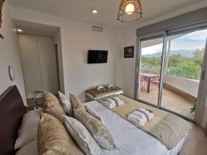 a bedroom with a large bed and a balcony at Apartment in Motril near Los Moriscos Golf in Motril +32 photos