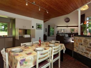 a dining room and kitchen with a table and chairs at Attractive holiday home in Stoumont with garden in Stoumont