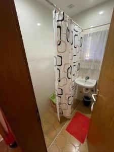 a bathroom with a shower curtain and a sink at Vidikovac Vrnjačka Banja in Vrnjačka Banja