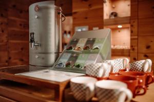 a box on a table with cups and a appliance at Hotel Alte Post in Grossarl