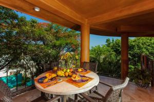 a table with fruit on it on a patio at Orange Sunsets, Lush Landscape, Intown, Privacy in Puerto Vallarta