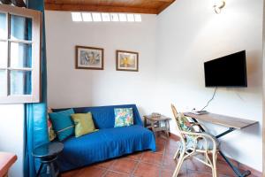 a living room with a blue couch and a table at El Nogal in San Juan de la Rambla