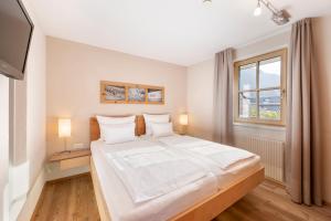 Rúm í herbergi á Gästehaus Bramböck