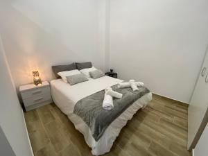 a bedroom with a bed with two towels on it at Apartamentos cruz roja B in Seville