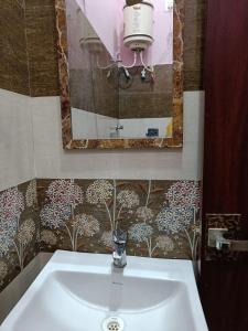 a white sink in a bathroom with a mirror at Hotel Subham Residency and Restaurant in Bikaner