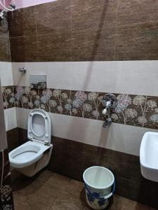 a bathroom with a toilet and a sink at Hotel Subham Residency and Restaurant in Bikaner