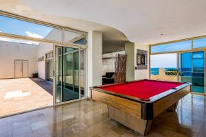 a pool table in a room with a view of the ocean at PB4 Nitta in Nuevo Vallarta