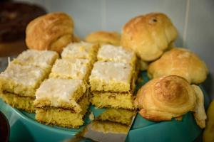 a plate of pastries and rolls on a table at Pousada Al Mare in Balneário Camboriú