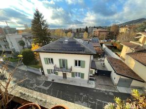 a white house with solar panels on top of it at Green Stay Bergamo in Bergamo