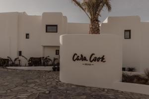 a white building with a sign that reads celta cut at Casa Cook Mykonos - Adults Only in Ornos