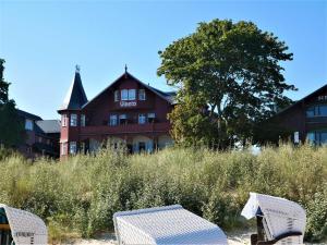 zwei Stühle und ein Tisch vor einem Gebäude in der Unterkunft Villa Vineta in Bansin