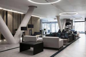a lobby with couches and tables in a building at Stylish Apartment in a 5 star hotel in Johannesburg