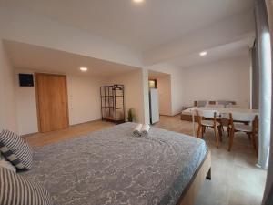 a bedroom with a large bed and a dining room at Telhinis Hotel & Apartments in Faliraki