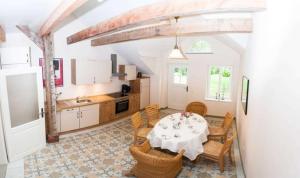 a kitchen and dining room with a table and chairs at Ferienwohnung 1 Holthusen 25514 in Weener +9 photos