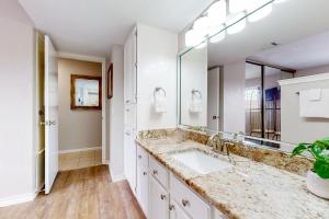 a bathroom with a sink and a large mirror at Mystic Harbor #104 in Padre Island +18 photos