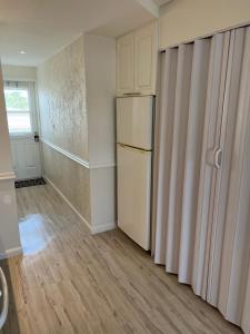 an empty kitchen with a refrigerator and a window at Expo Motel in Hollywood