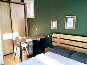 a bedroom with a bed and a desk and a table at T2 stylé/calme et confortable in Arcachon