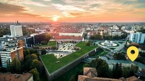 a view of a city at sunset with a park at Bastion Apartment in Timişoara