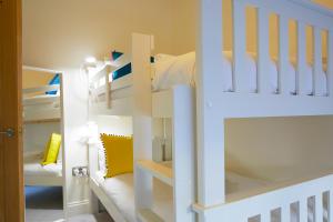 a bunk bed room with a white bunk bed at THE STOOP, Stunning sea views! in Scarborough
