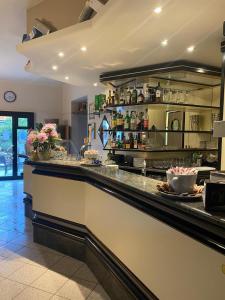 a kitchen with a bar with flowers on the counter at Locanda L'Ombrosa in Vezzano Ligure