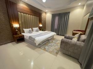 a large bedroom with a bed and a couch at Admire Apart' Hotel - Jeddah in Jeddah