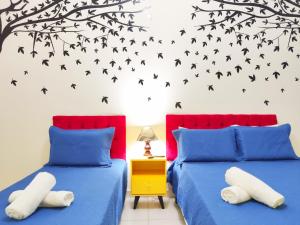 1 dormitorio con 2 camas con pájaros en la pared en Studio Beira-Mar reformado na Av Atlantica TC207, en Río de Janeiro