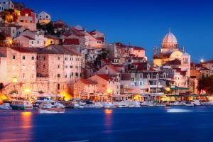 a city with boats in the water at night at ST. CLARA OLD TOWN in Šibenik