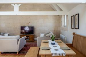 a living room with a table and a couch at The Old Library in Painswick