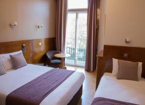 Postel nebo postele na pokoji v ubytování Garden View Hotel