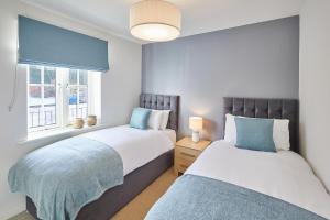 a bedroom with two beds and a window at Host & Stay - Harbour View in Whitby